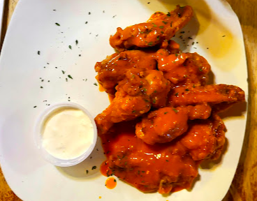 Riverside Market signature dishes BBQ Chicken Pizza
Chicken Wings
Pastrami Sandwich